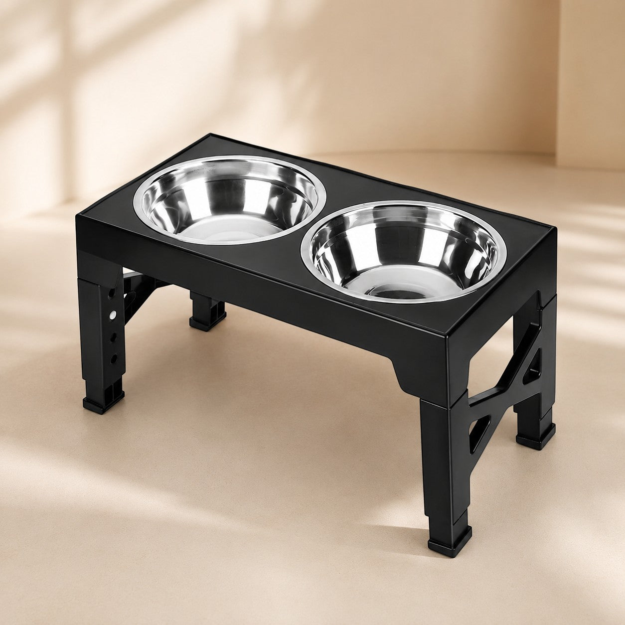 Nuzzo AdjustaBowl 5-level elevated dog feeder with two stainless steel bowls in a black adjustable stand.