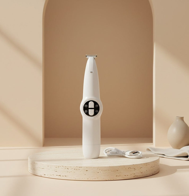 Nuzzo 2-in-1 cordless pet grooming trimmer in white with precision blades for paw and face hair on a stone pedestal