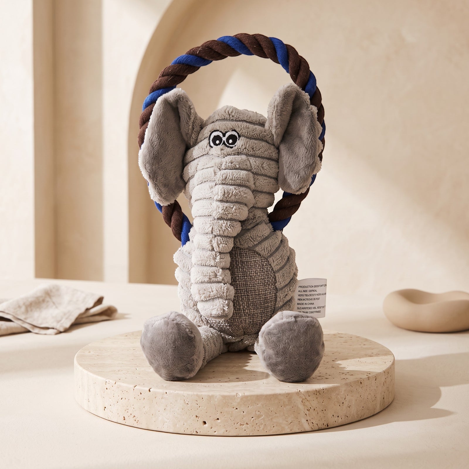 Nuzzo elephant plush pet toy made of corduroy with a blue and brown cotton rope handle for interactive play