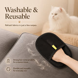 Nuzzo FurLift black mesh pet hair removal glove cleaning grey sofa fabric with a white cat in the background