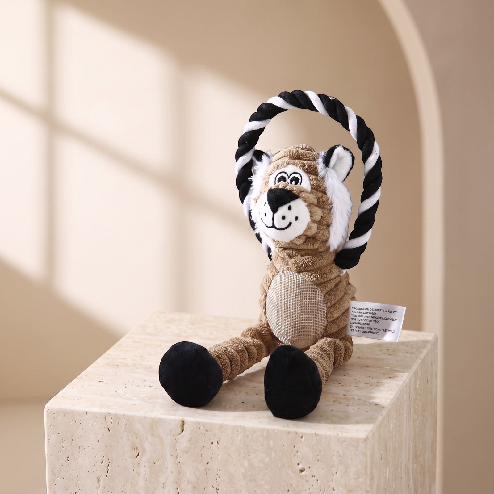 Nuzzo plush monkey pet toy made of brown corduroy with a black and white cotton rope ring for interactive play