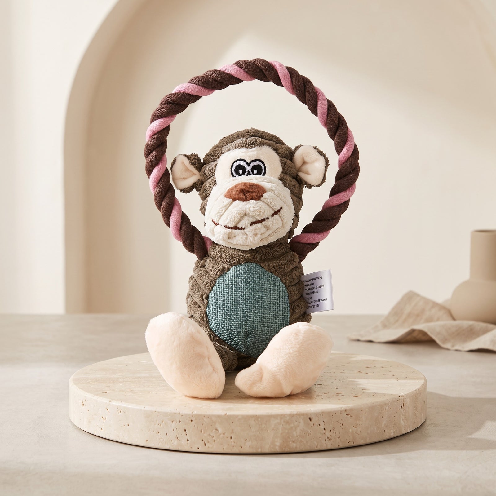 Nuzzo monkey plush pet toy made of brown corduroy with a pink and brown cotton rope ring for interactive play