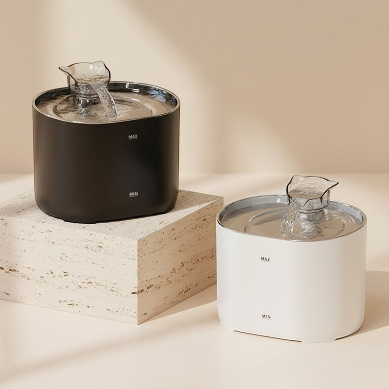 Nuzzo PureFlow smart pet water fountains in black and white, featuring a modern design on stone pedestals.